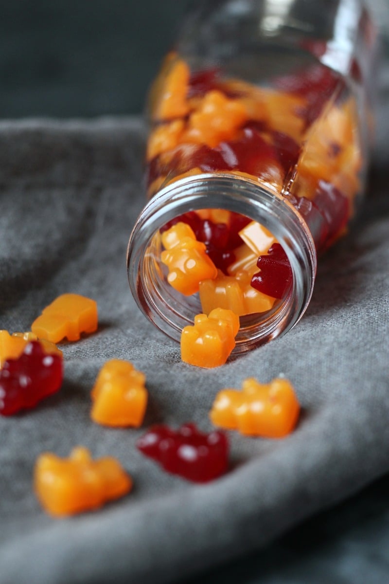 Gummy Bears Multivitamin (Vegan, Gluten-free) in a glass jar on a grey table cloth. 