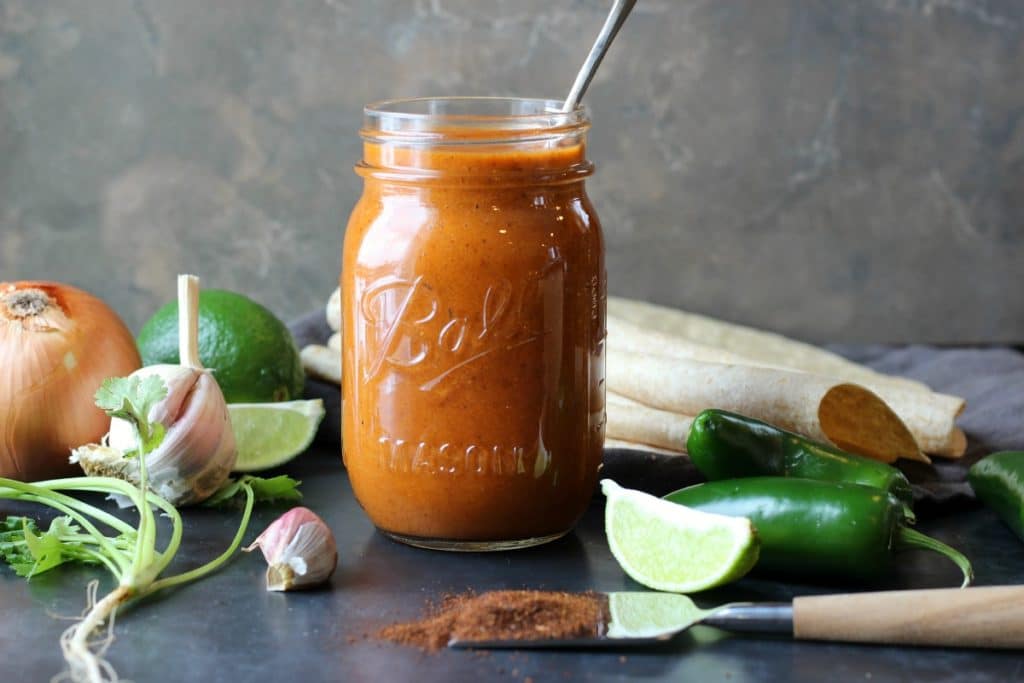 a mason jar filled with enchilada sauce.