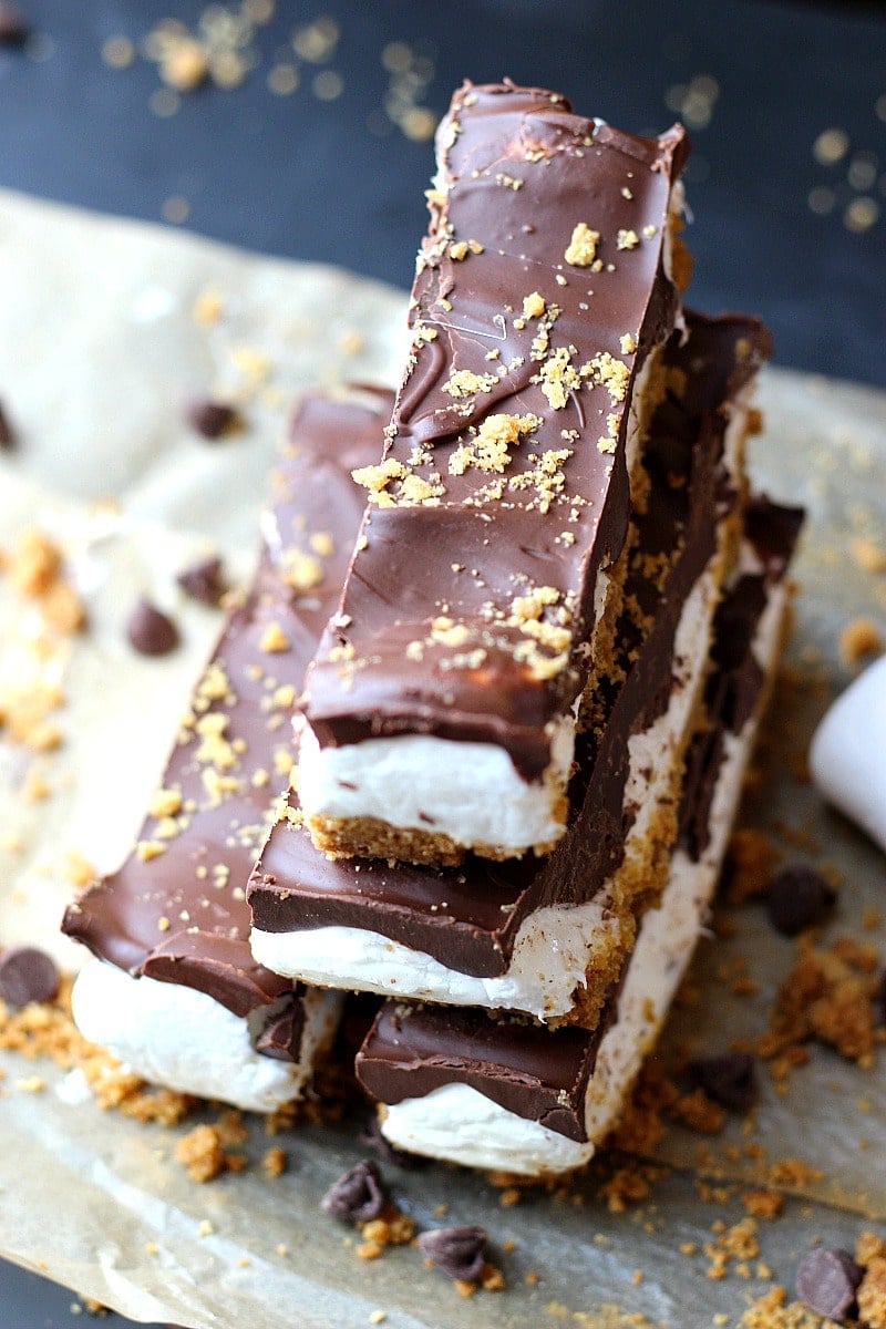 No-Bake S’mores Bars with chocolate marshmallow fluff and graham crackers. Bars are sliced and stacked. 