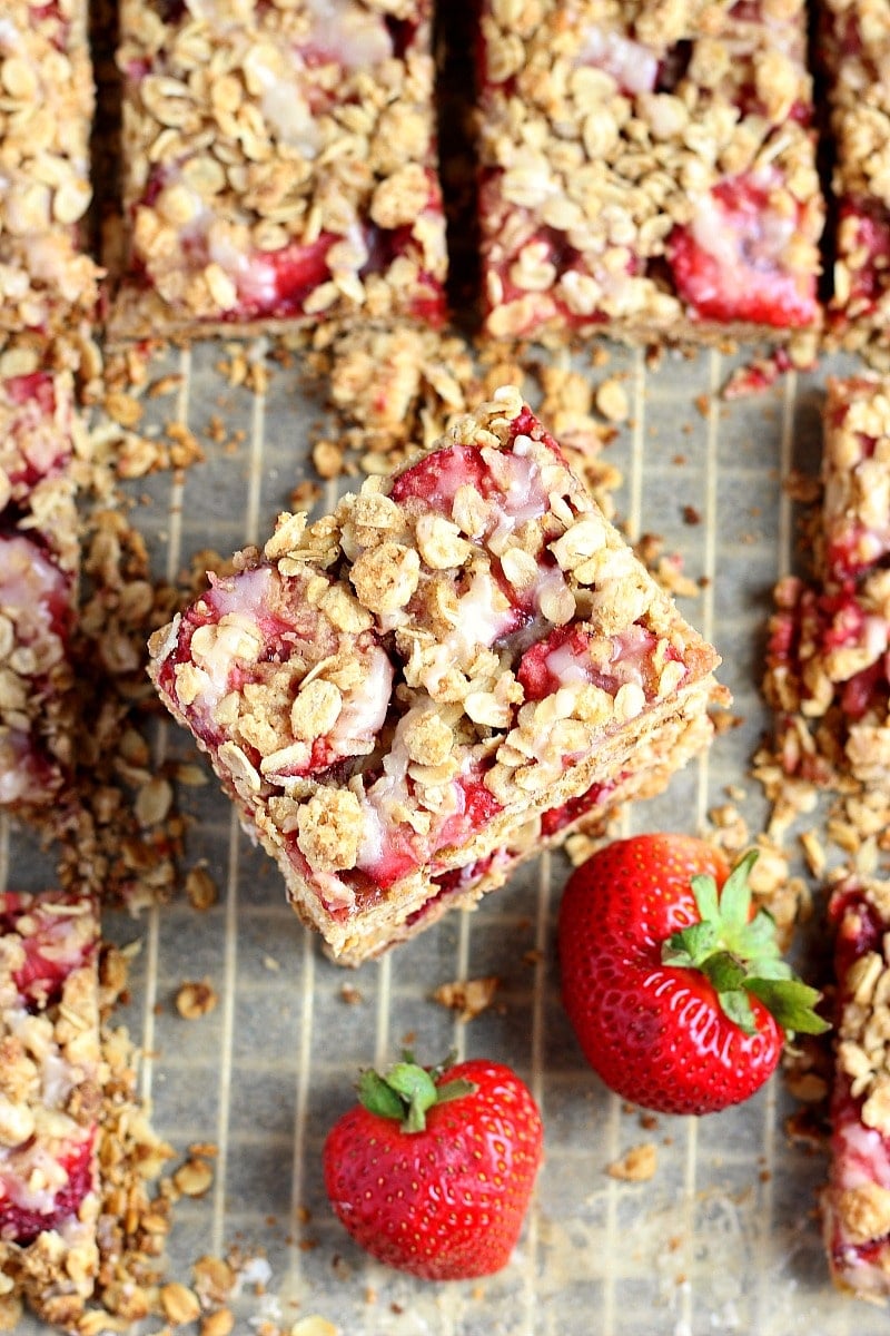overhead view of gluten free strawberry crumble bars stacked on top of each other.