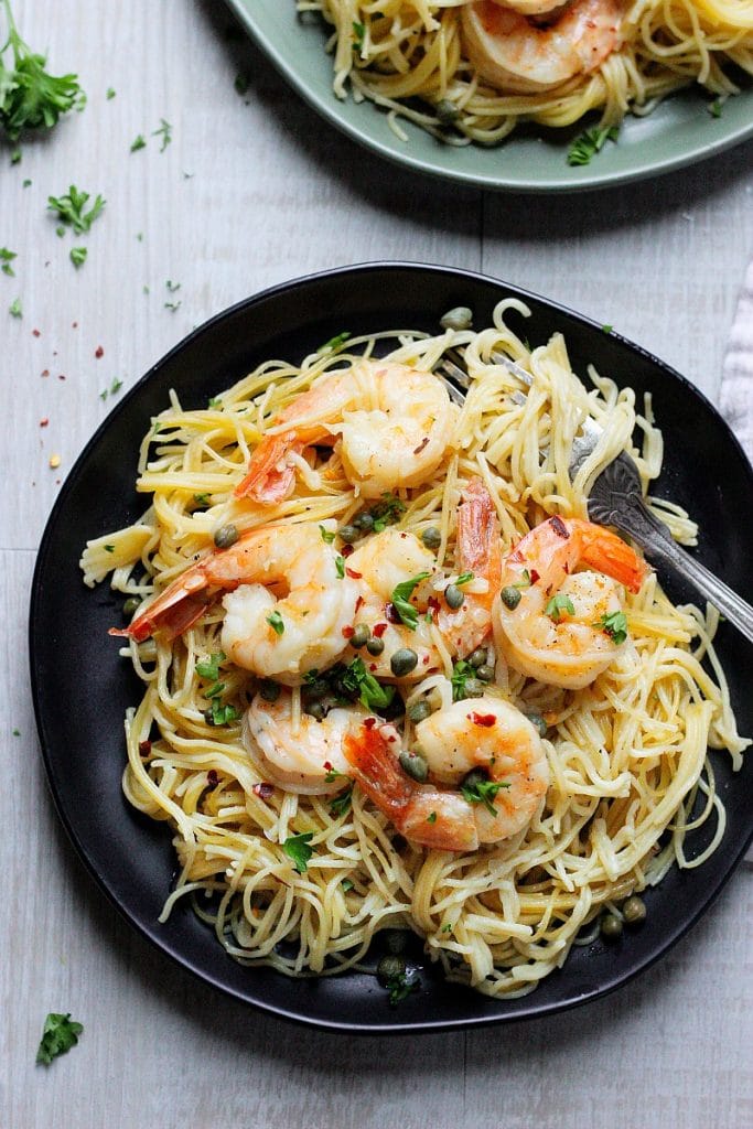 3-minute Instant Pot Shrimp Scampi with angel hair pasta, cooked in a fragrant shallot-wine broth, topped with capers and fresh parsley!