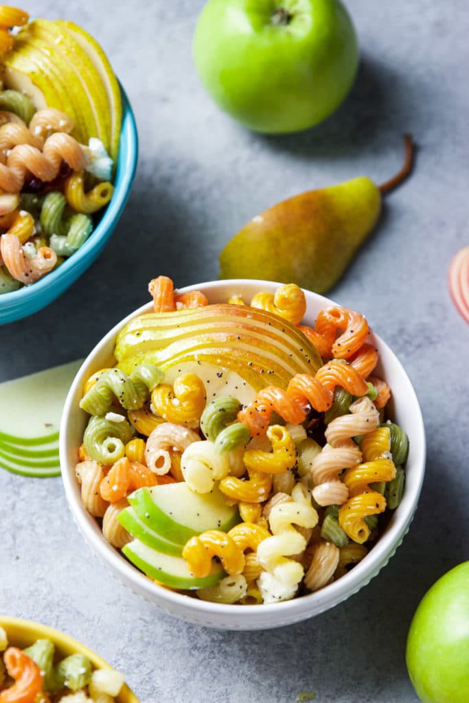 Two bowls of seasonal fall harvest pasta salad with apples and pears. 