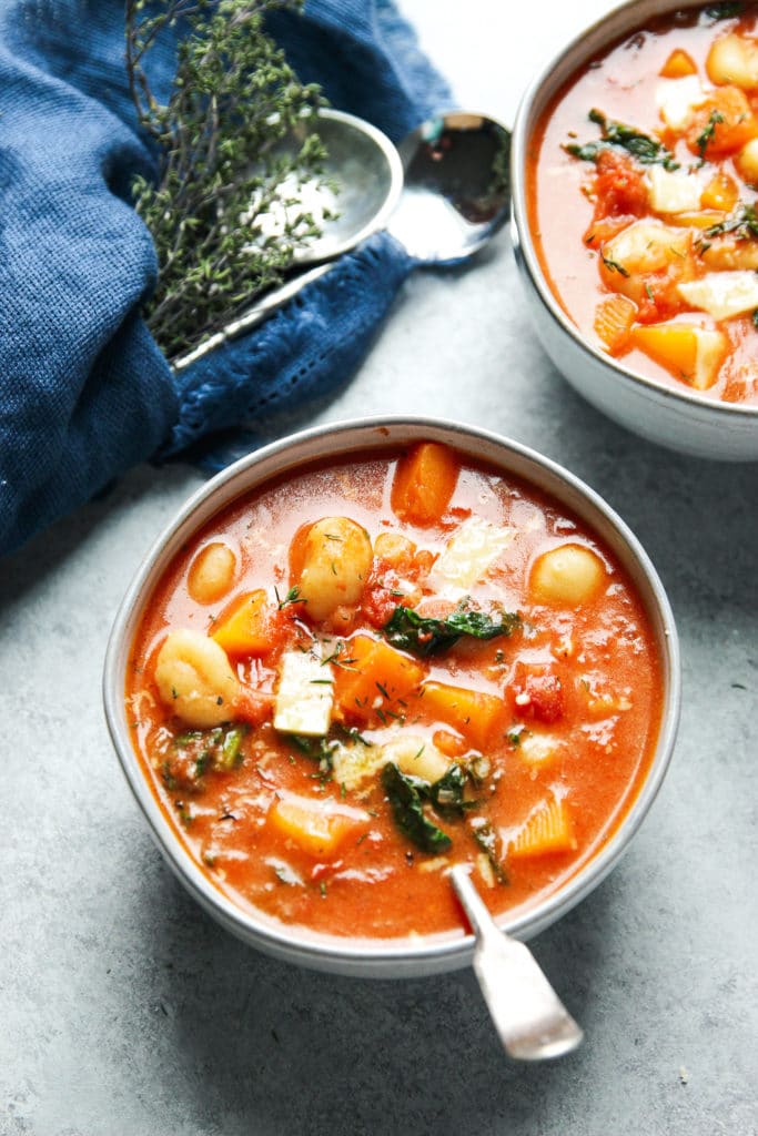 Tomato Gnocchi Soup in two bowls with a spoon