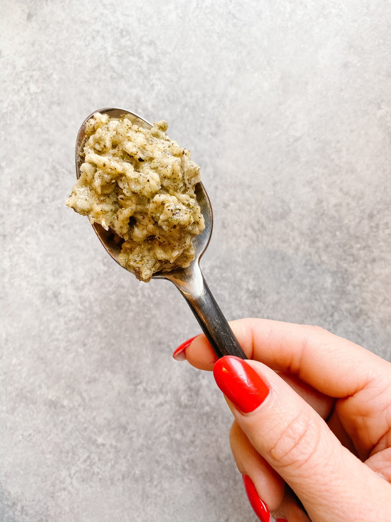 close up on a spoonful of garlic herb paste.