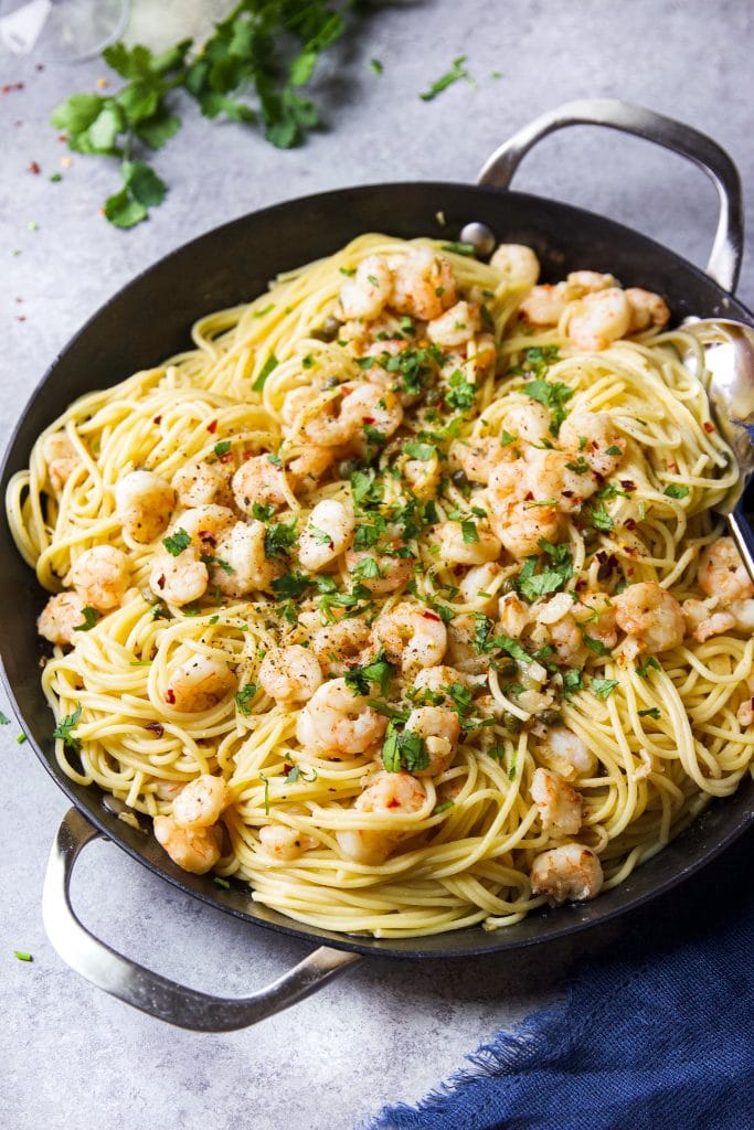 Shrimp scampi pasta served in a skillet with two handles