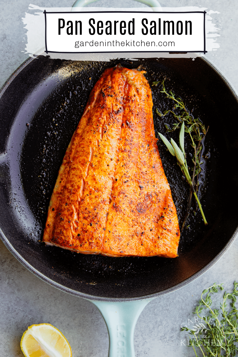 skillet salmon in cast iron pan with fresh herbs. 