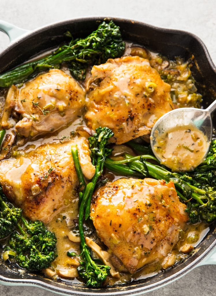 Chicken thighs braised in a delicious creamy mushroom sauce with leeks and broccoli. 