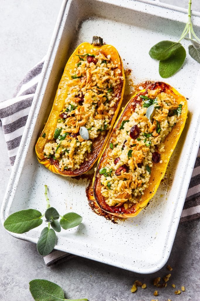 roasted delicata squash stuffed with quinoa, spinach, walnuts and cranberries