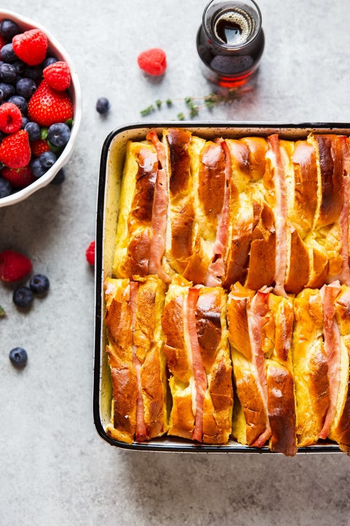 Ham and Cheese Breakfast Casserole served with warm syrup and a side of berries!