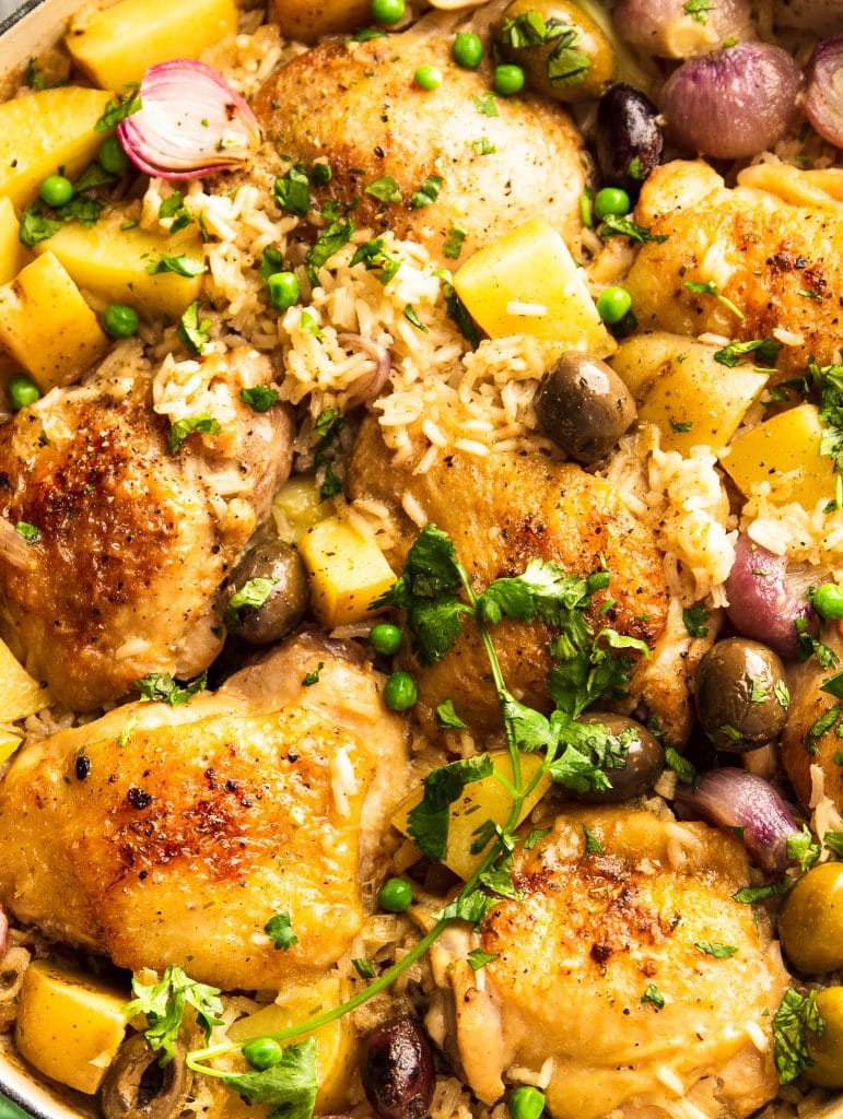 chicken thighs with rice, potatoes, red onions and olives