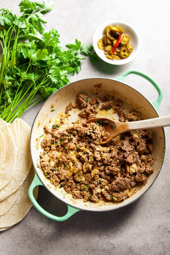 cooked ground beef and melted cheese in a large pot.