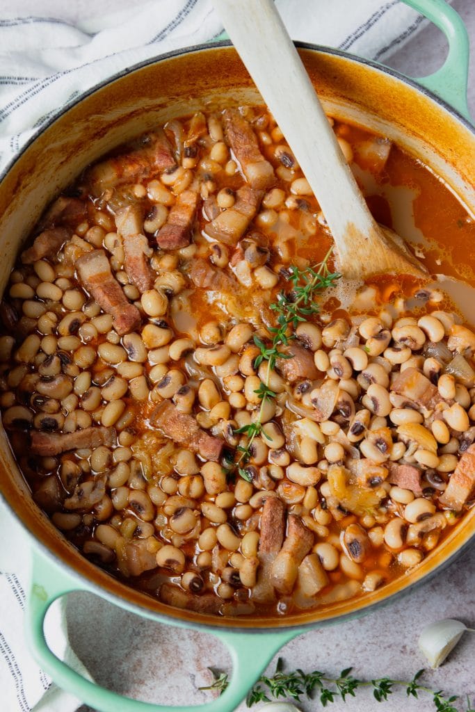 black eyed peas recipe in a pot with wooden spoon
