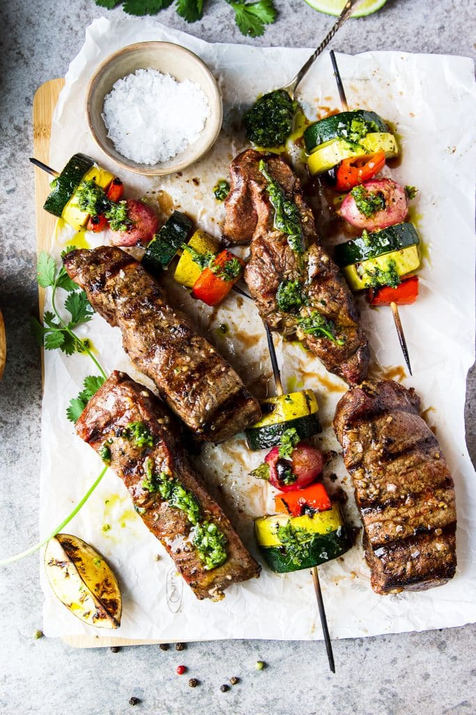 Grilled churrasco flat iron steaks. Veggie kebabs, topped with cilantro chimichurri sauce. 