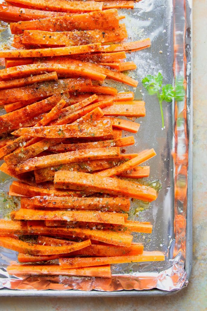 raw carrots seasoned and ready to go in the oven. 