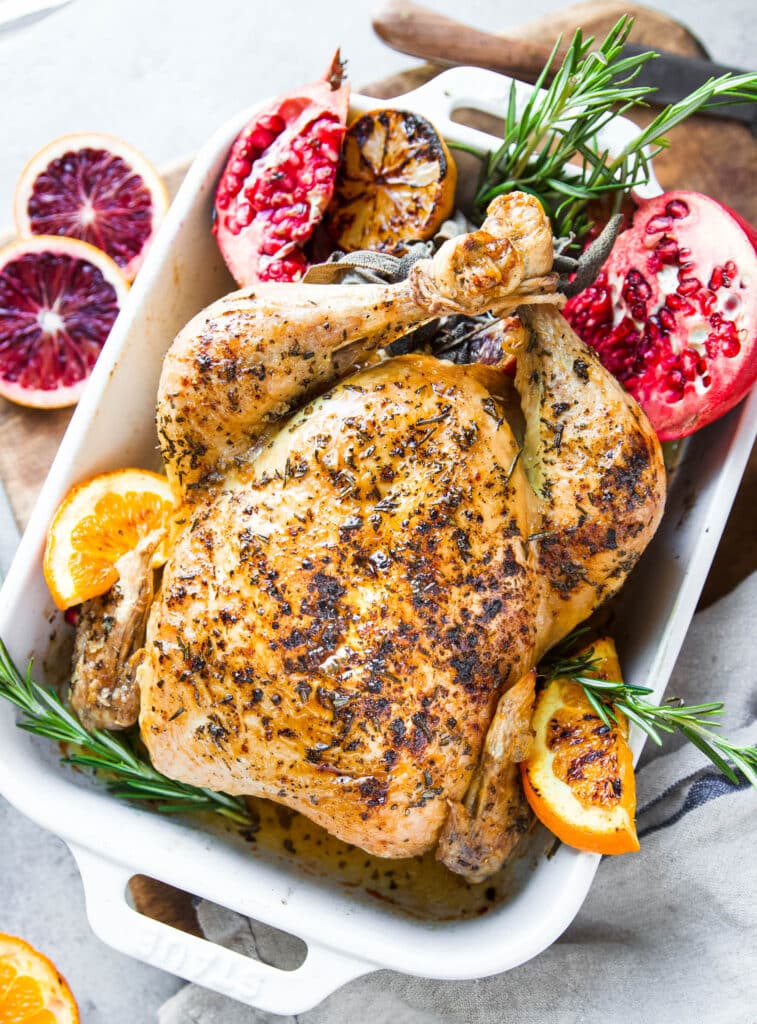 Whole herb roasted chicken with fresh herbs and citrusy orange and pomegranate.