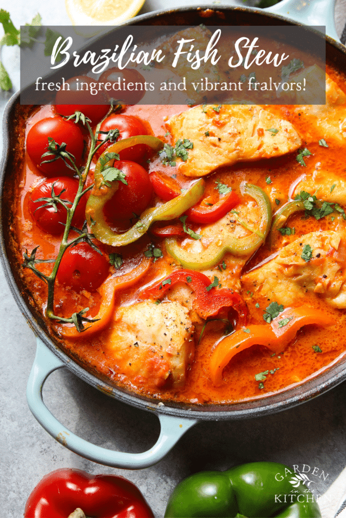 A cast iron skillet with fish stew, peppers and tomatoes on a rich tomato broth topped with cilantro.
