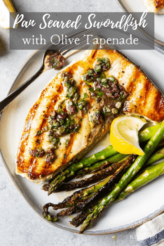 pan seared swordfish topped with olive tapenade fresh lemon and a side of asparagus