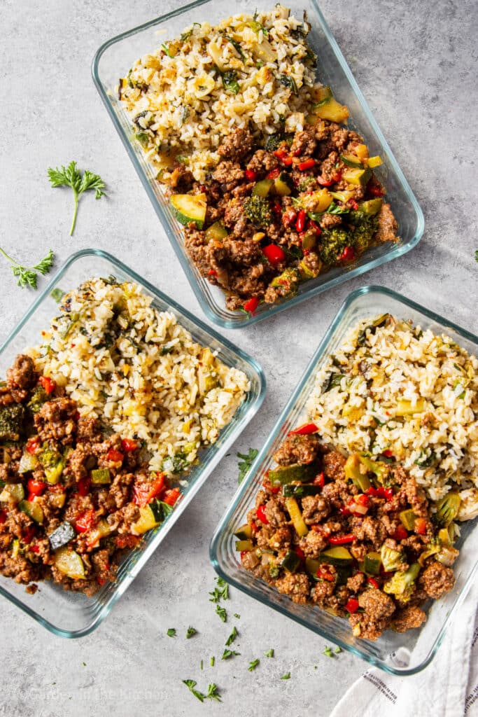 Ground beef and rice in meal prep bowls. 