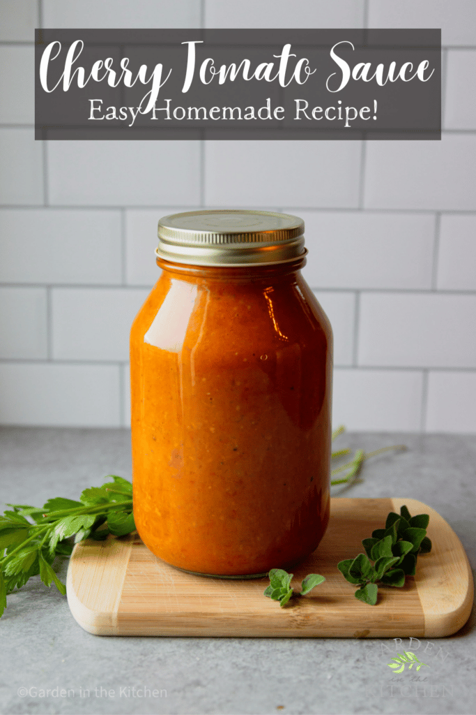 Jar of tomato sauce made with cherry tomatoes. Fresh kitchen herbs. 