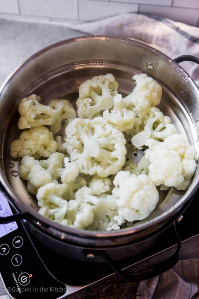 Steamed cauliflower florets in a pot.
