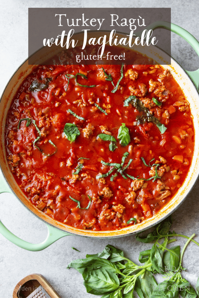A large skillet with turkey ragù in red sauce. Garnished with fresh basil.