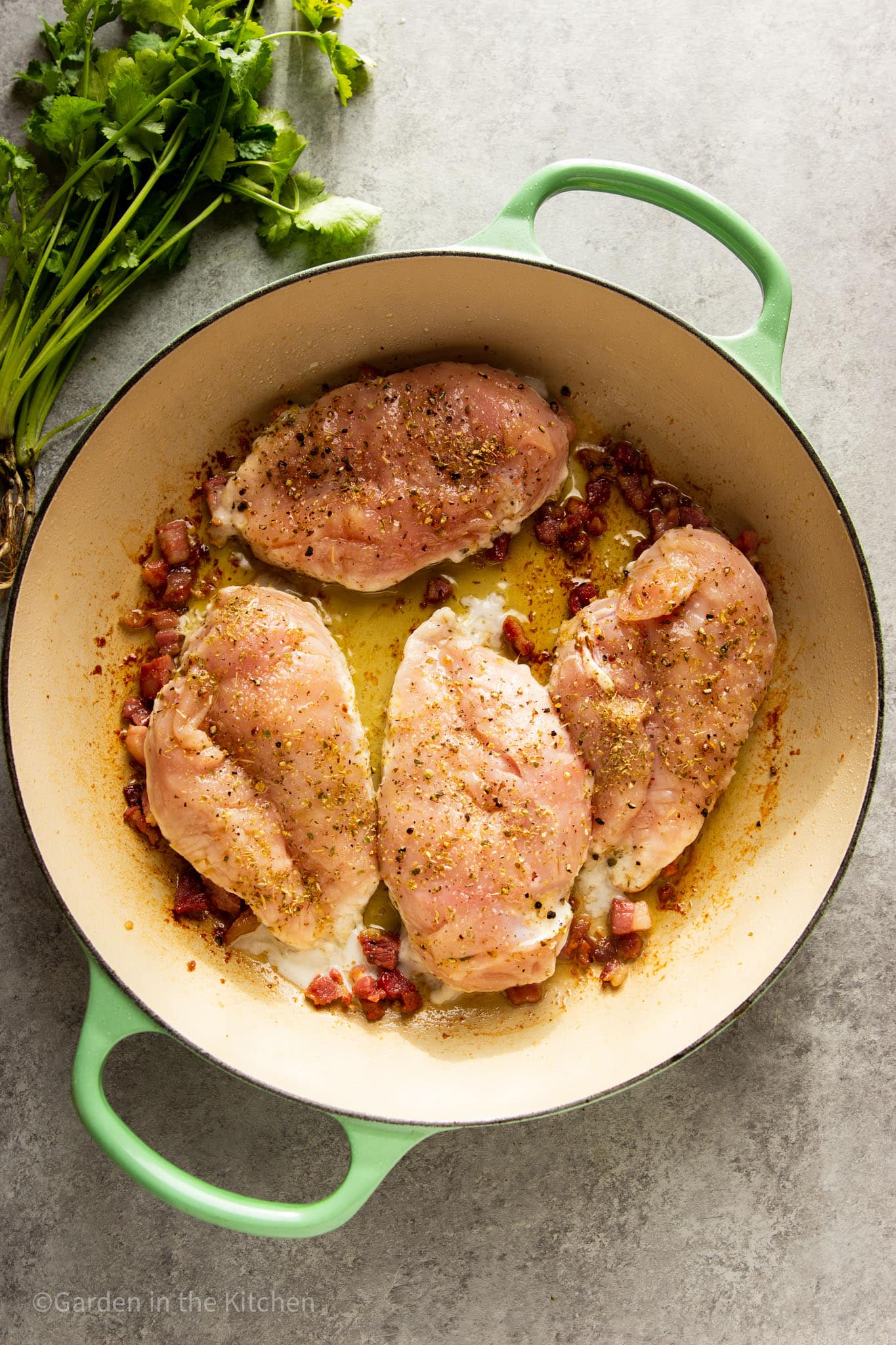 frying pancetta and chicken breasts in an oiled pot.