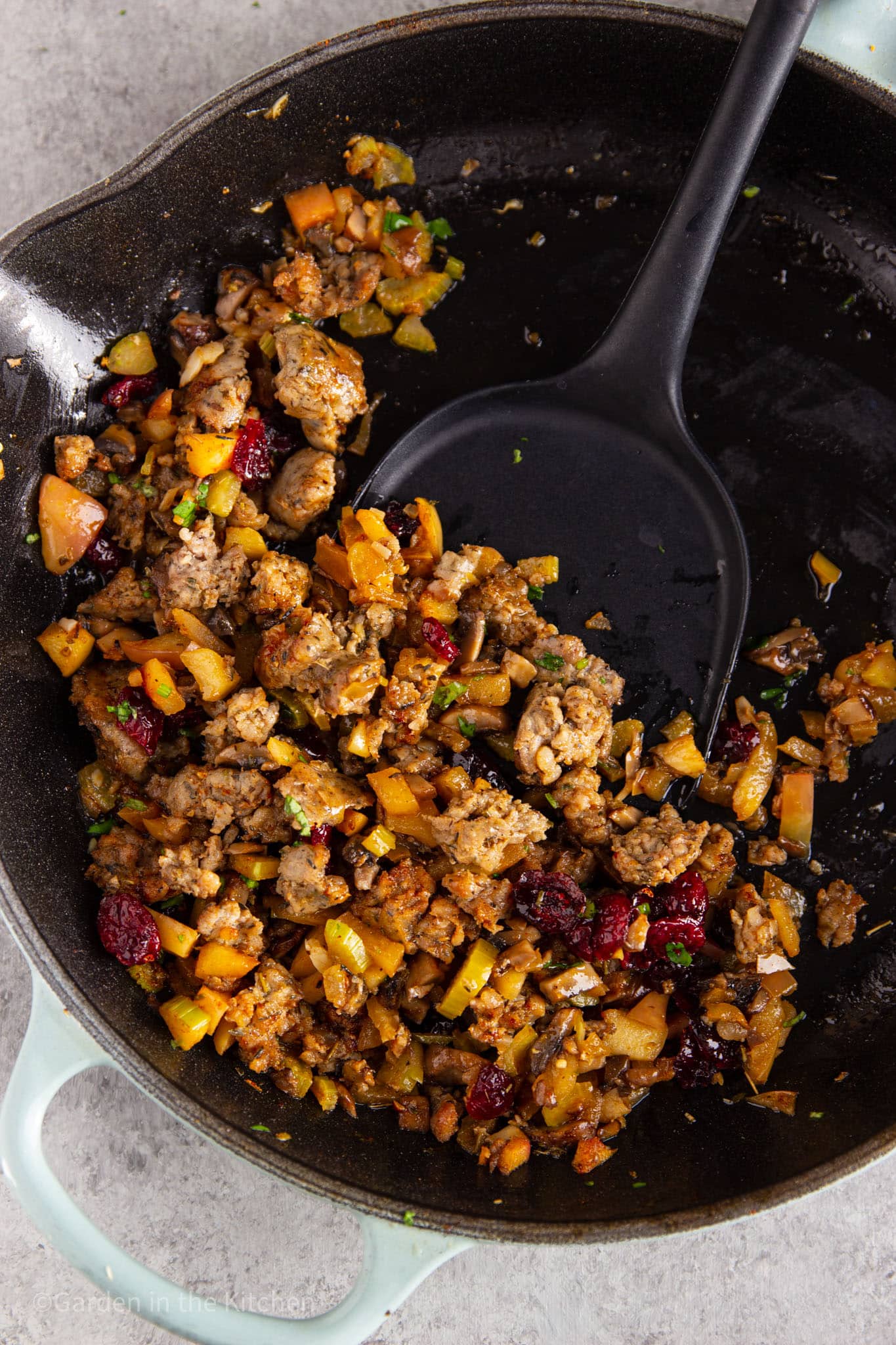 Sausage and apple stuffing in cast iron skillet.