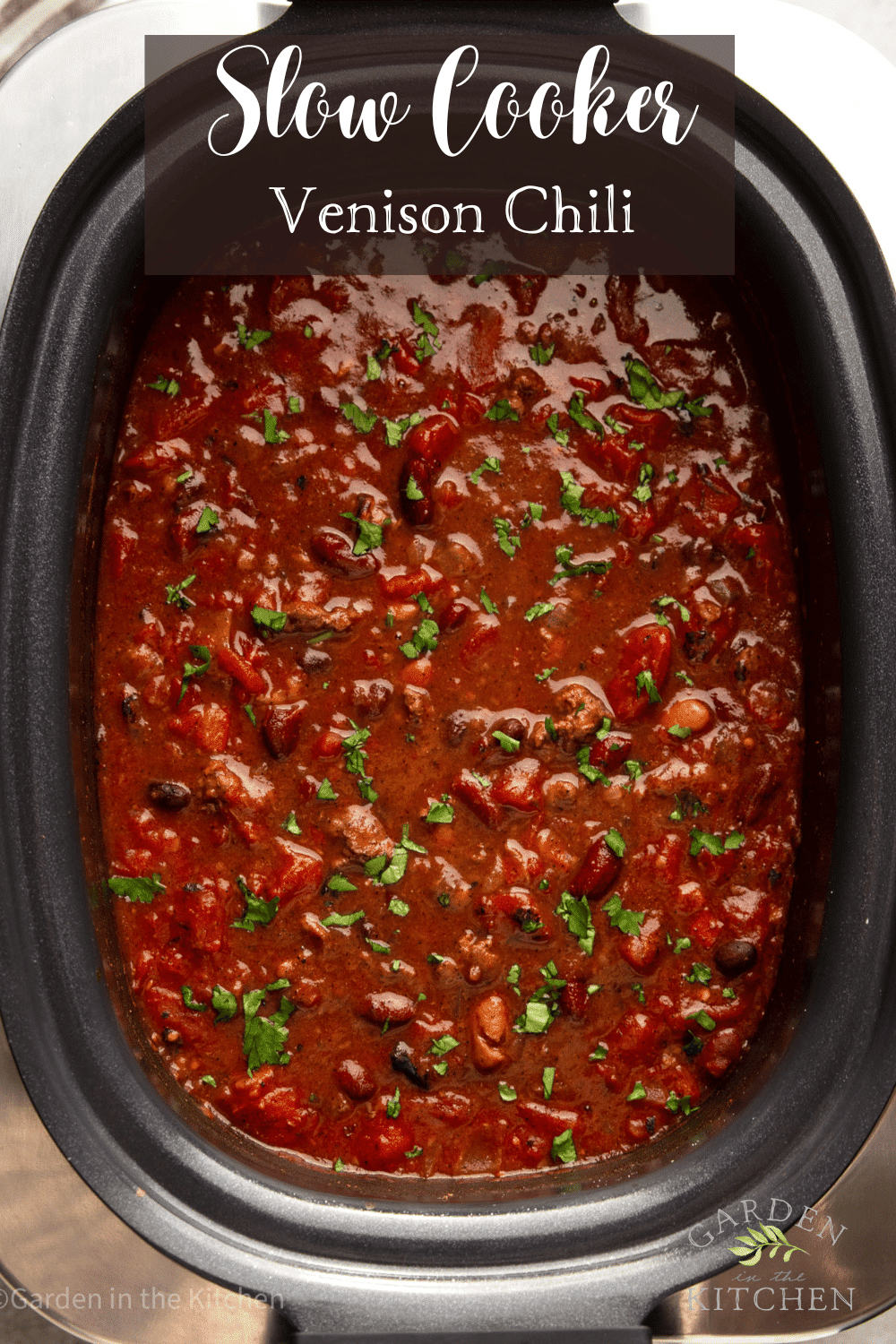 pinterest image of a large black slow cooker full of venison chili.