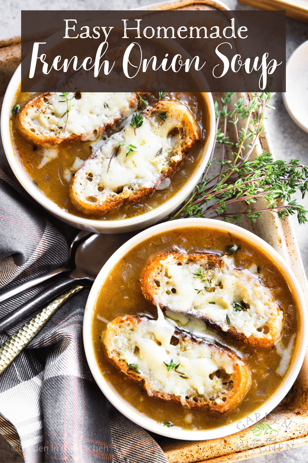 pinterest image of 2 white bowls of french onion soup topped with toasted bread and melted cheese.