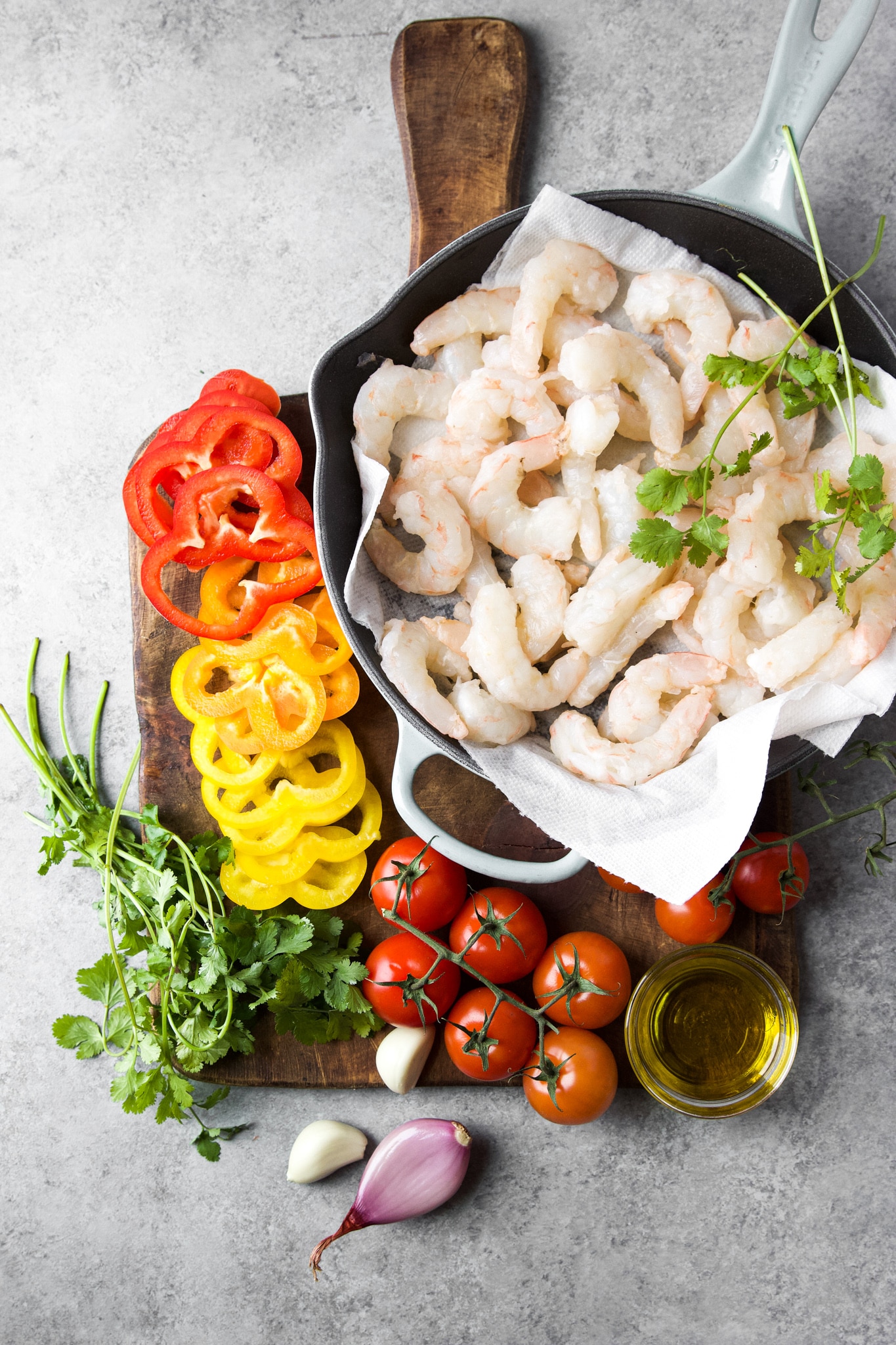 Ingredients for shrimp stew moqueca de camarão measured on a cutting board.