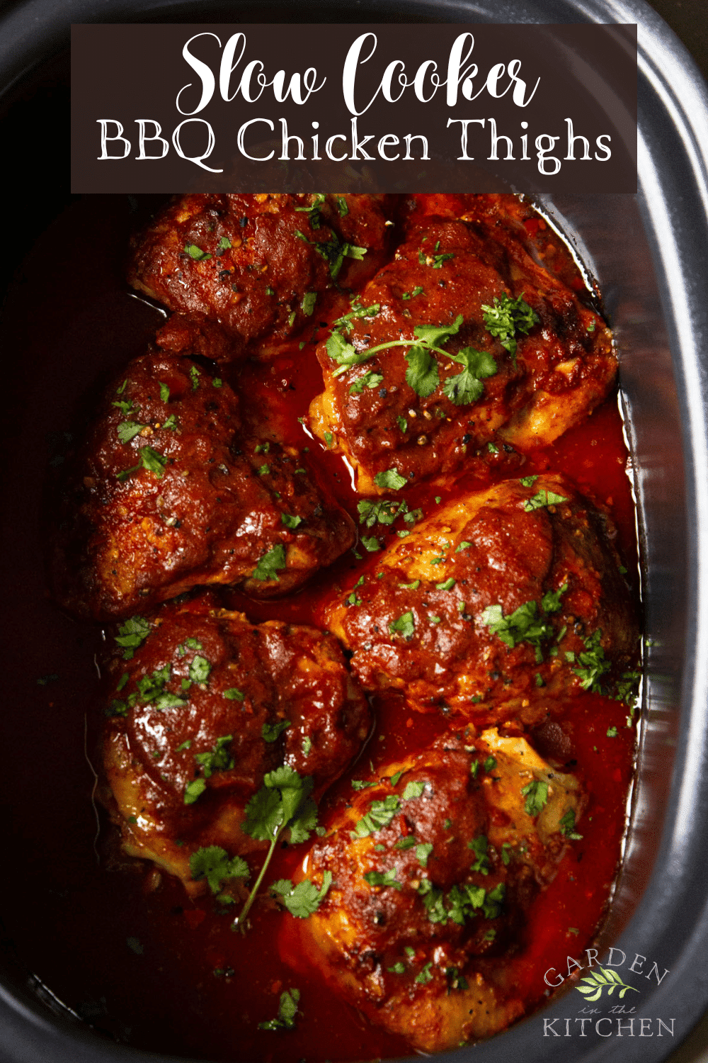 pinterest image of on bbq chicken thighs garnished with green herbs in a large black slow cooker.