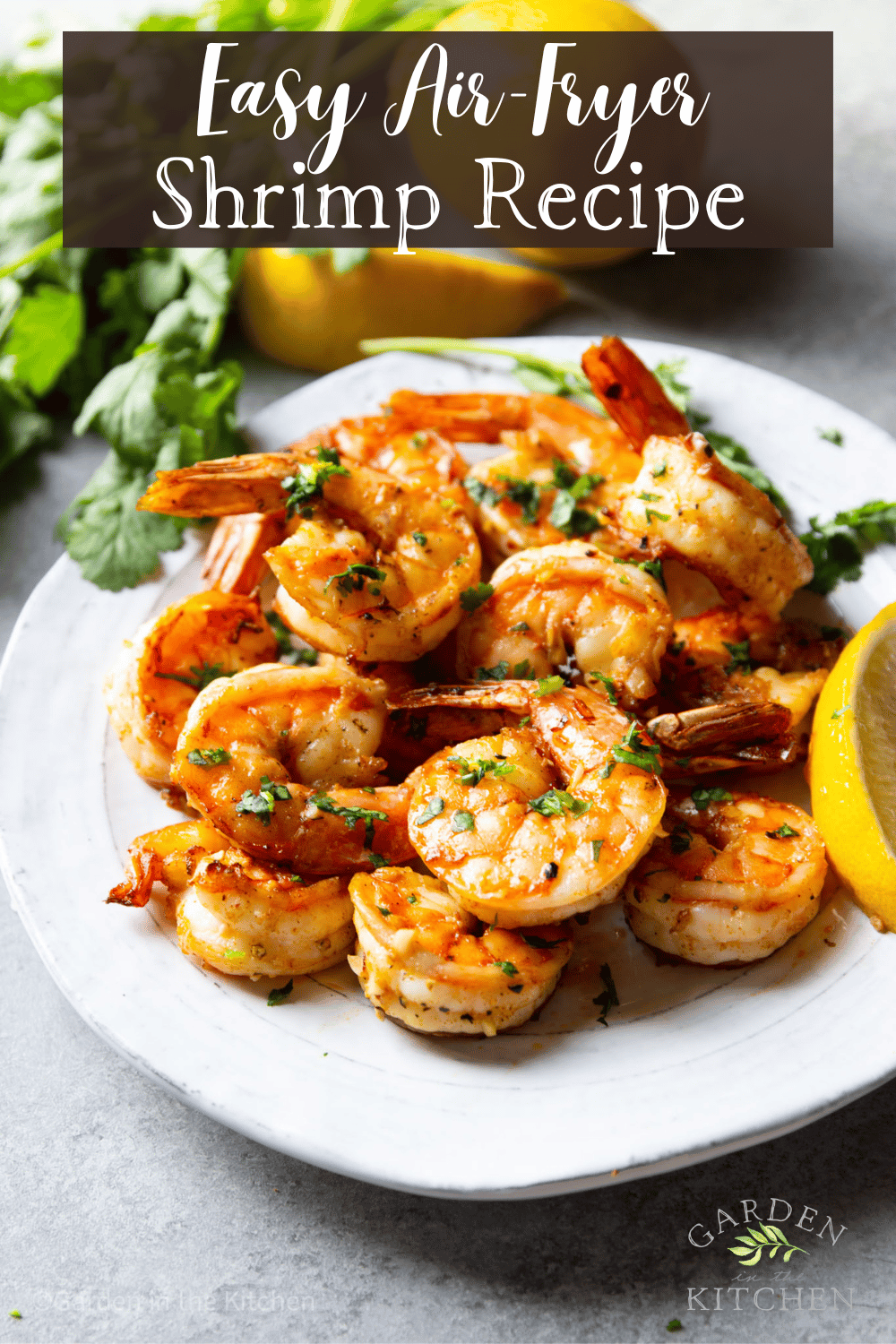 pinterest image of a plate of cooked air fryer shrimp on a white plate.