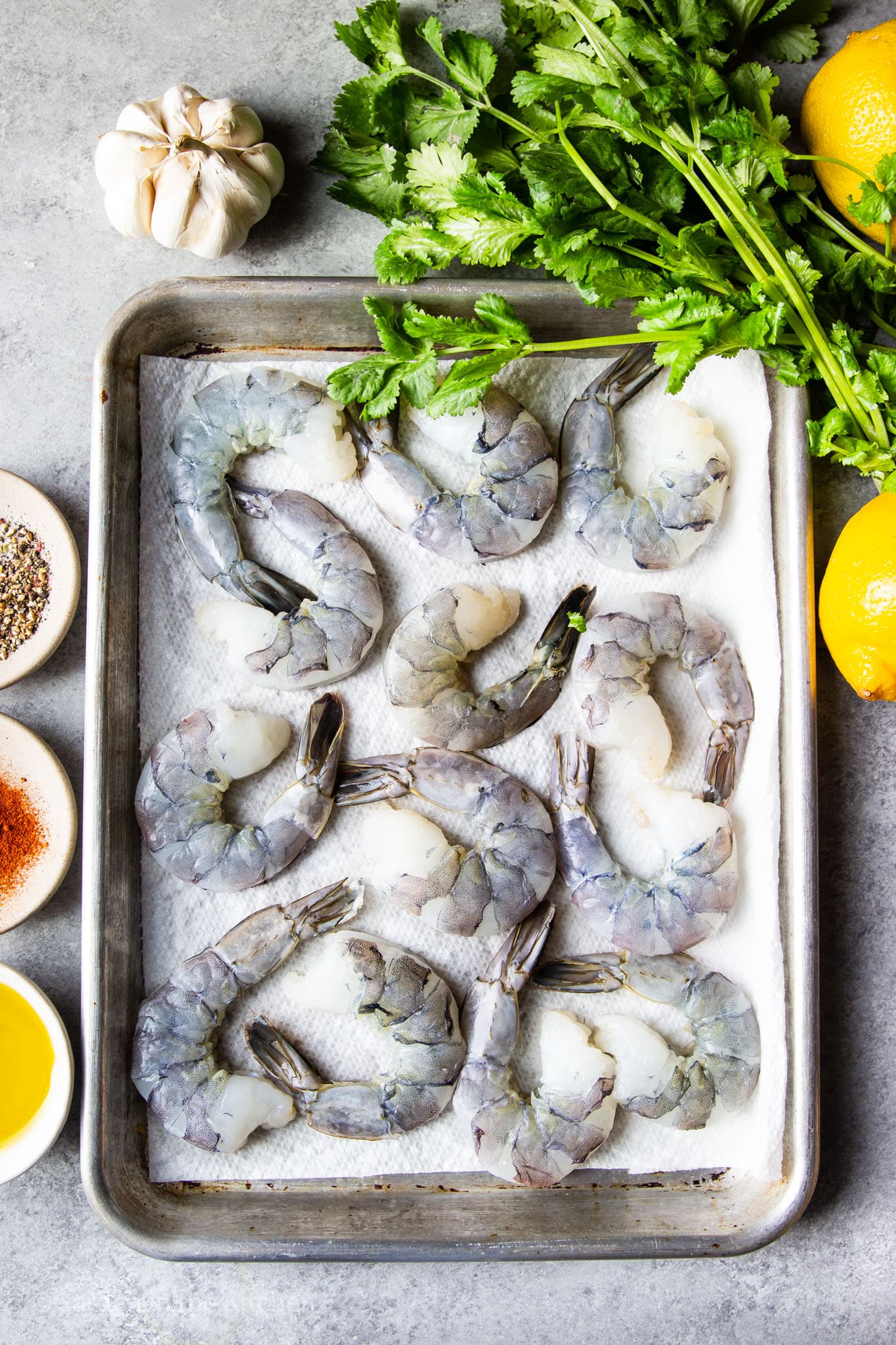 raw shrimp on a paper towel-lined baking sheet.