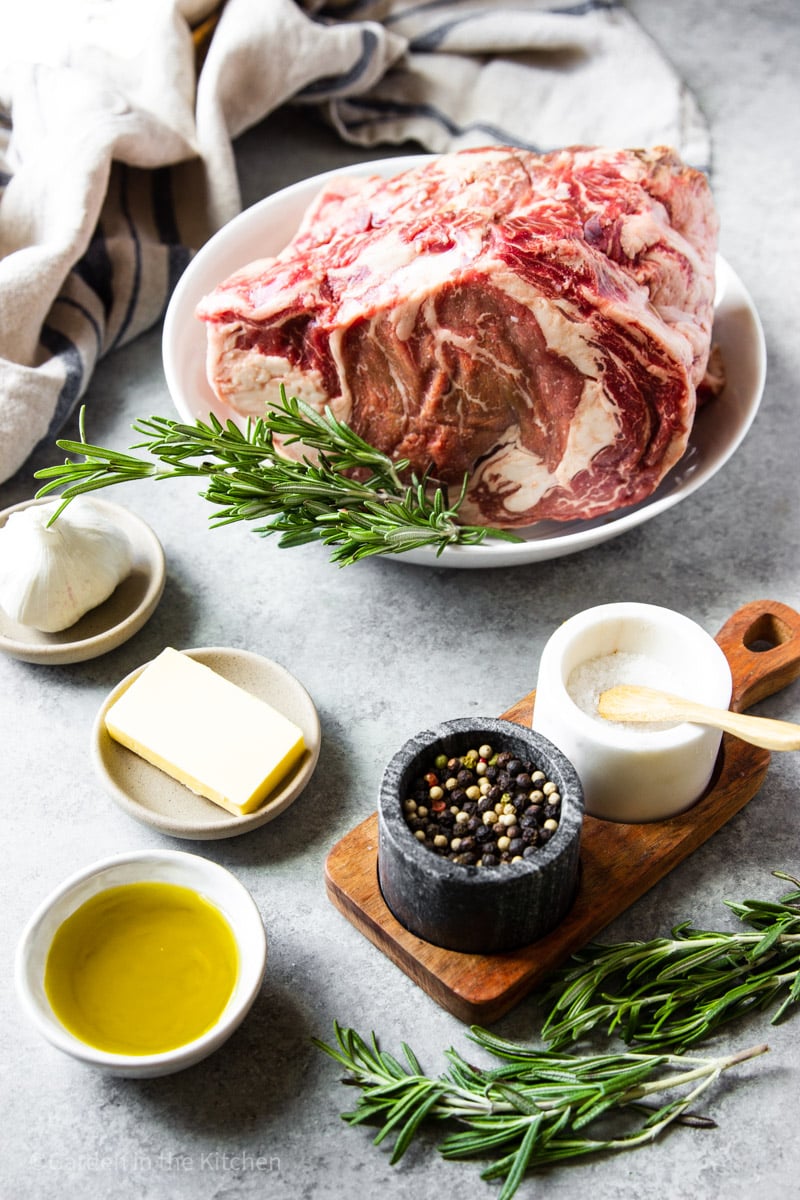 ingredients for classic prime rib roast on individual white plates.