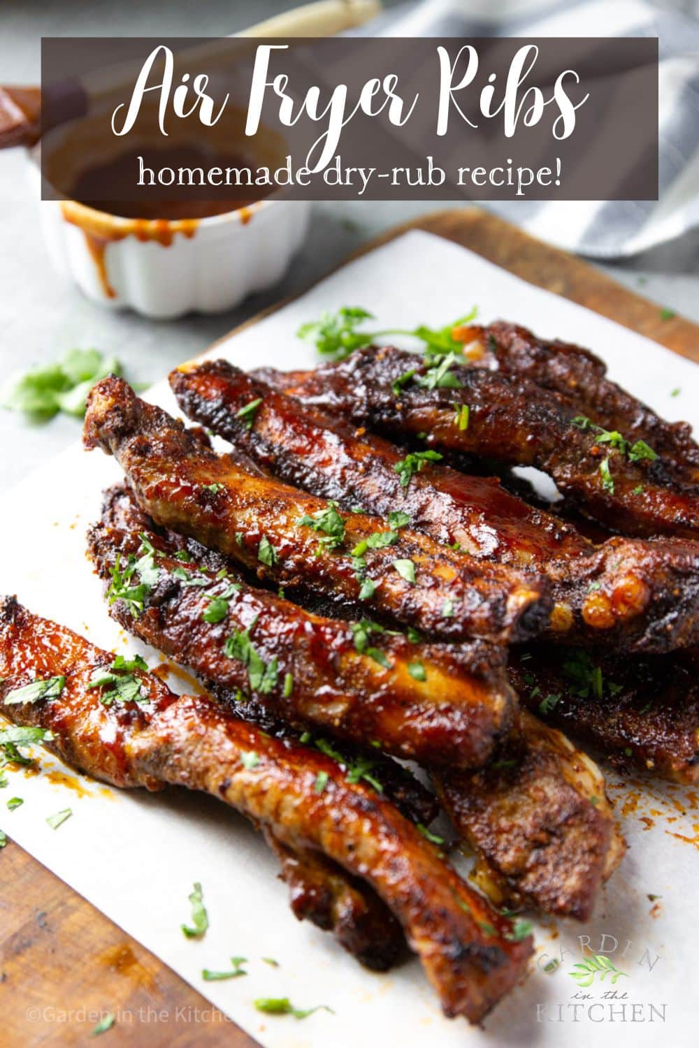 pinterest image of barbecue spare ribs piled on top of each other on a sheet of parchment paper.