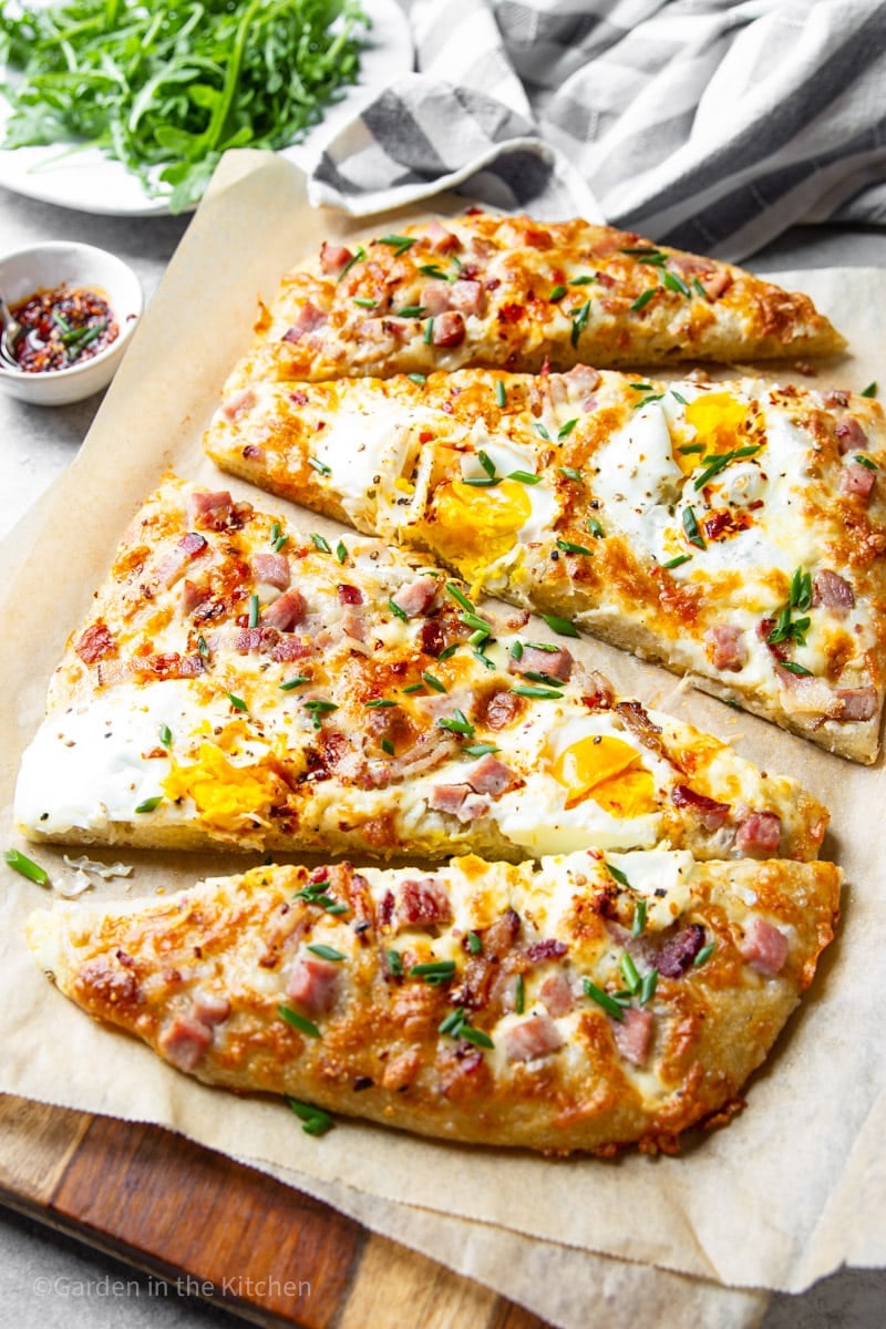 Ham, egg and cheese breakfast pizza slices.