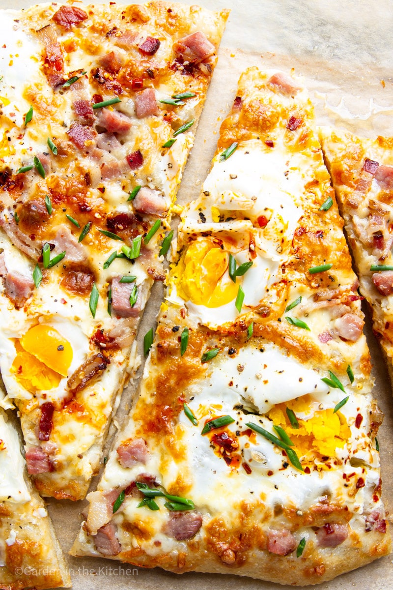 Breakfast pizza with ham, egg and cheese slices. 
