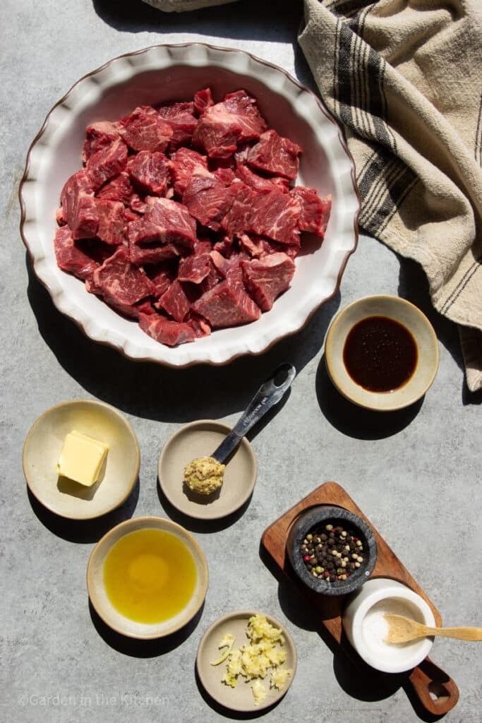 Raw steak tips, butter, mustard, olive oil, coconut aminos, salt, peppercorns, whisk, garlic