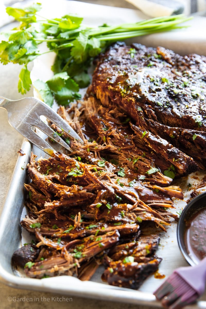 Cooked, shredded slow cooker barbeque brisket and cilantro.