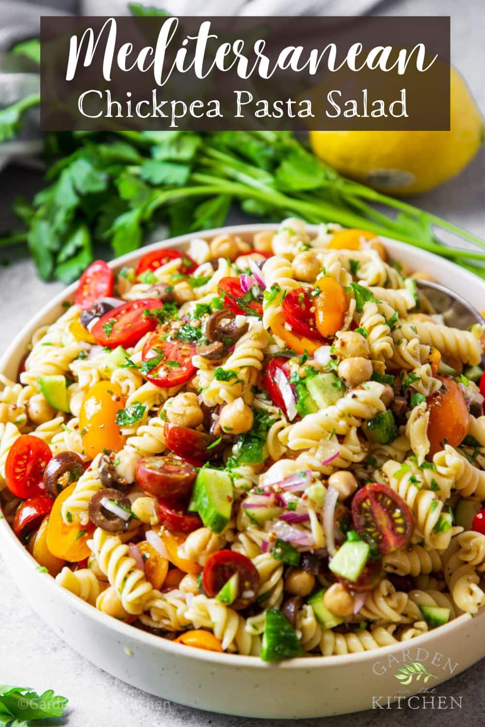 A big bowl of chickpea pasta salad with mediterranean flavors. 