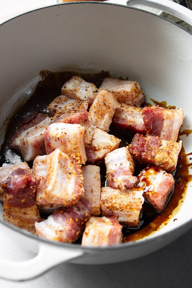 Diced pork belly in a bowl with the sweet sauce. 