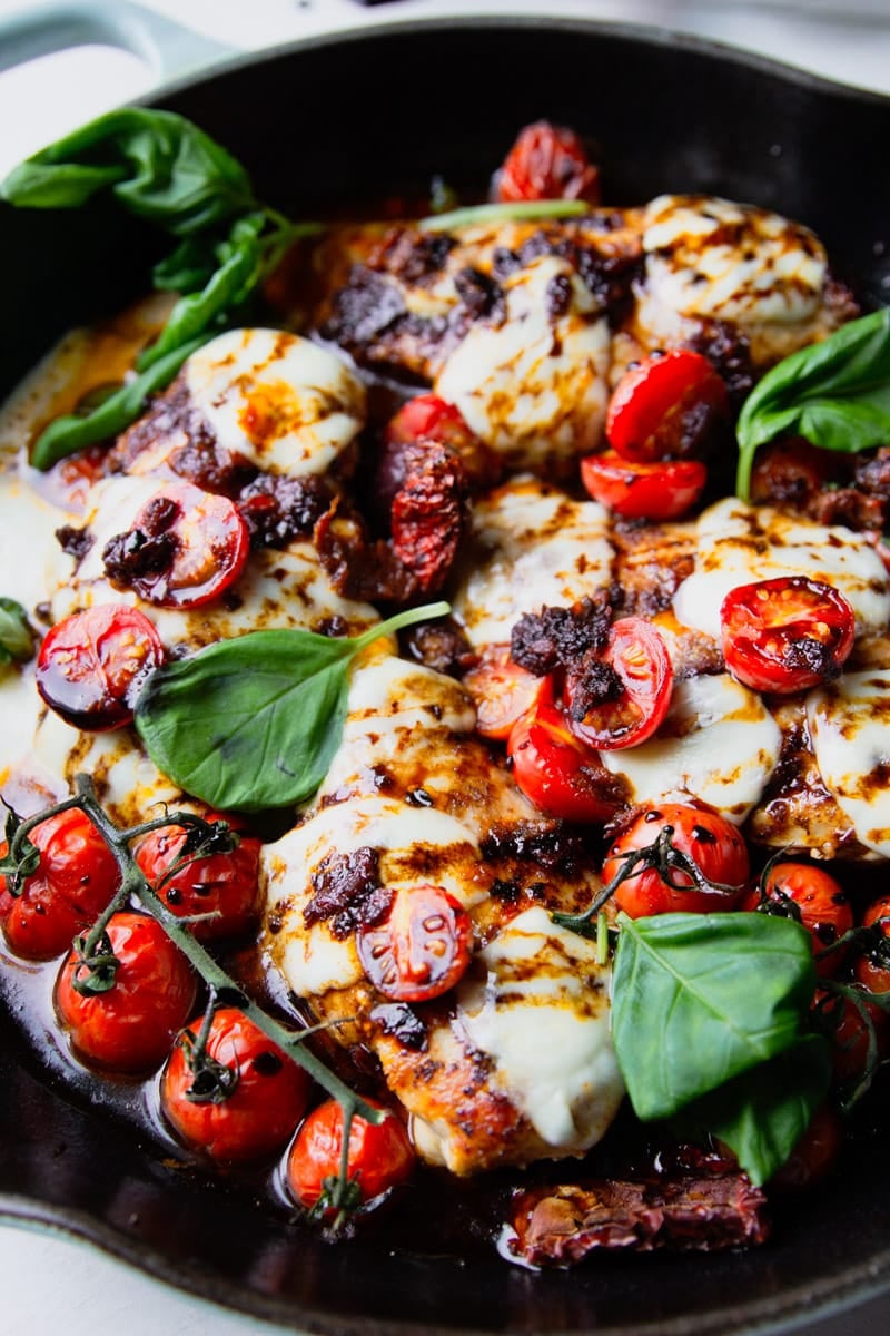Cast iron skillet with balsamic glazed chicken, tomatoes, fresh mozzarella and basil. 