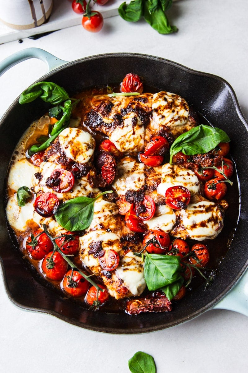 Cast iron skillet with balsamic glazed chicken, tomatoes, fresh mozzarella and basil. 