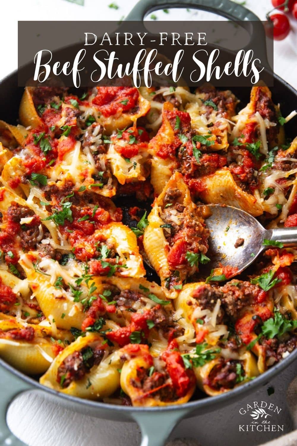 Baked beef stuffed pasta shells and a stainless steel spoon.