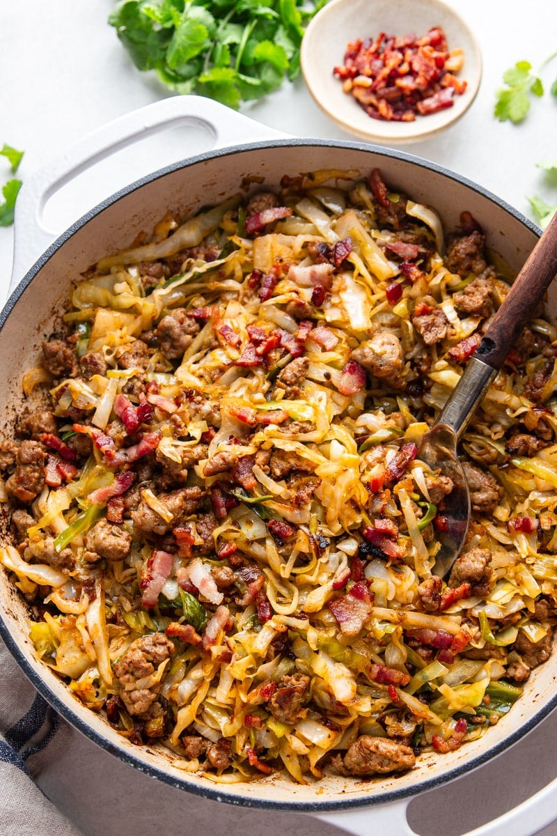 Fried cabbage and sausage, bacon chunks, cilantro. 