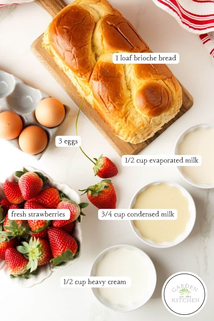 Brioche bread, eggs, strawberries, evaporated milk, condensed milk, heavy cream and a white and red dish towel.