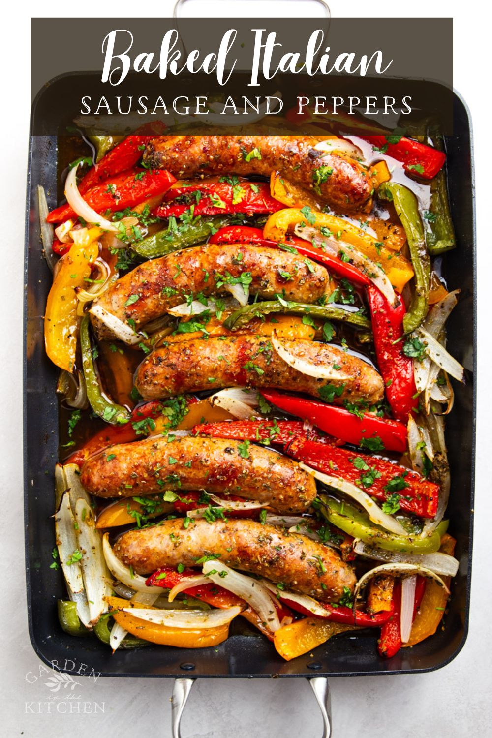 sheet pan sausage, peppers and onions in baking sheet with handles.