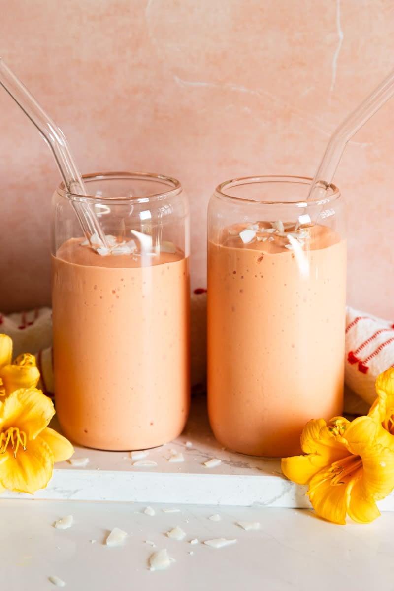 Tropical fruit smoothie and flowers.