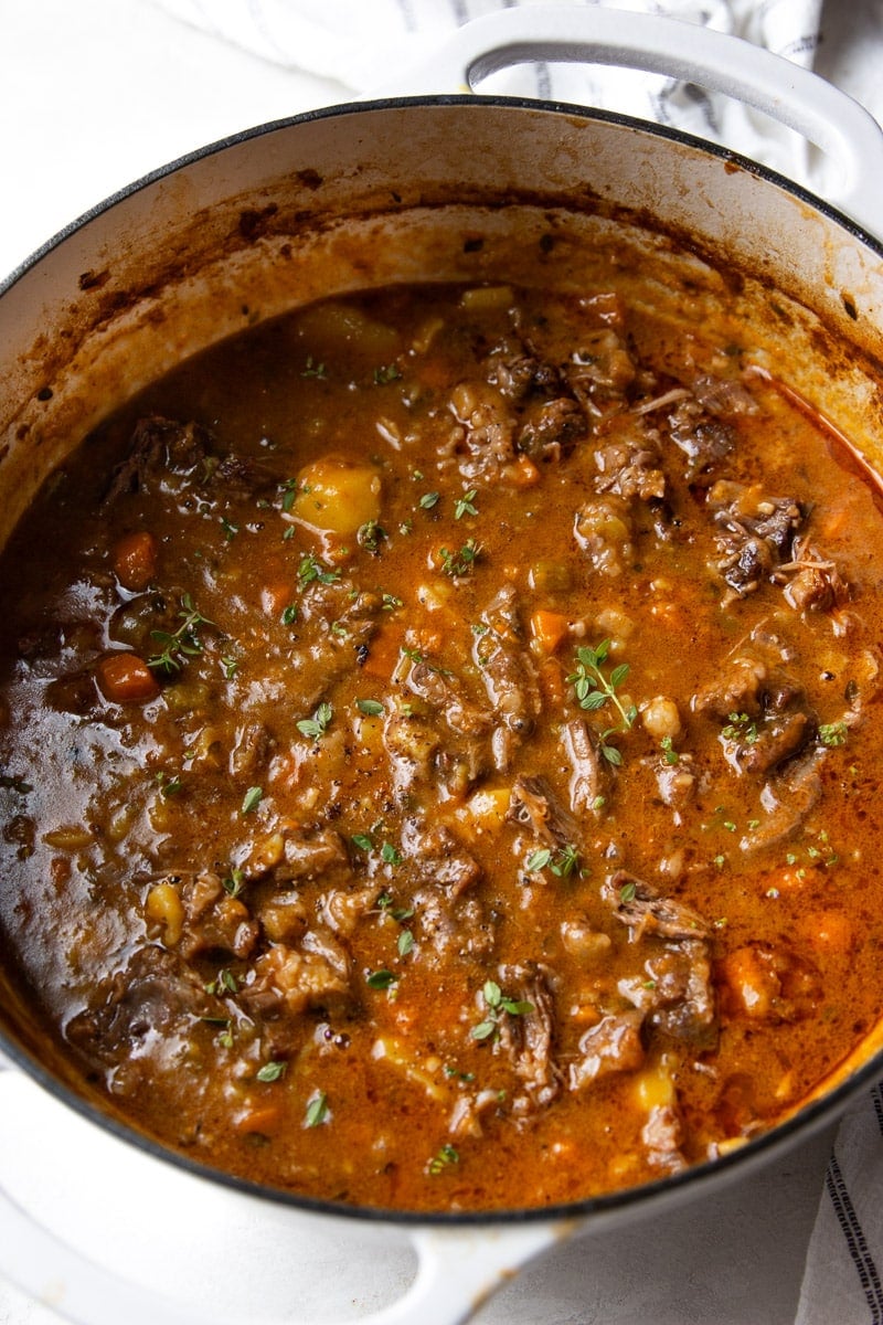 Oxtail soup and a white and black dish towel. 