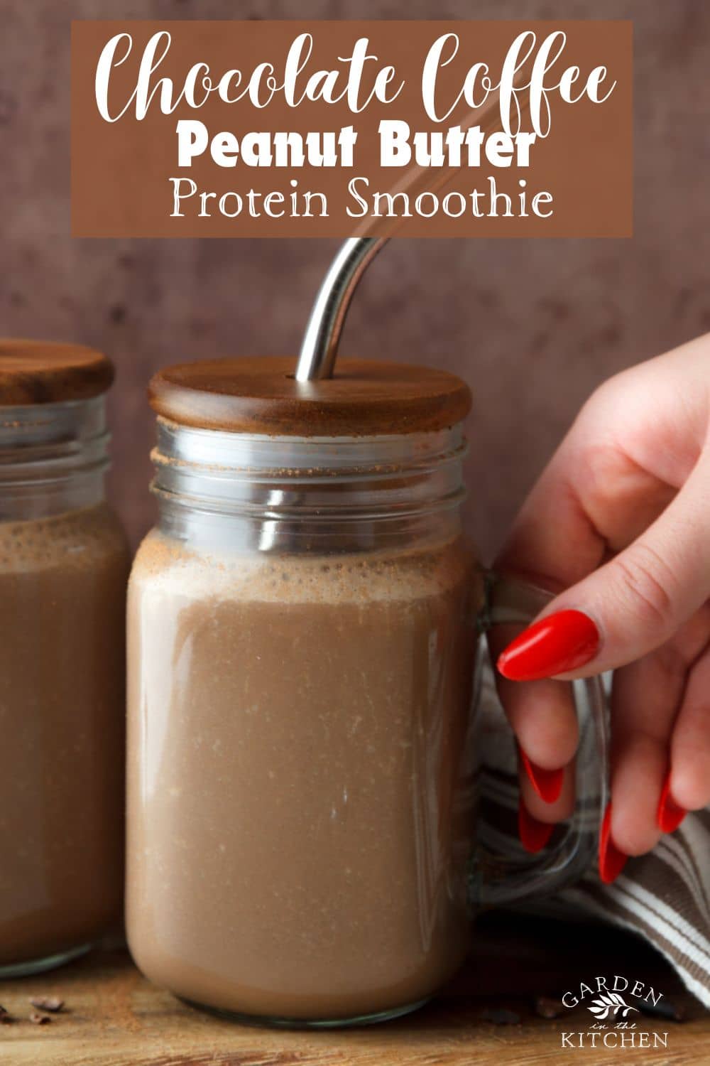 Chocolate Coffee Protein Smoothie in a glass jar on a wooden cutting board, and a white and brown dish towel. 